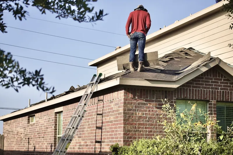 Professional roofer working on a residential roof in The Bar Ranch